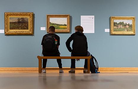 Students looking at art in a Quick Center gallery